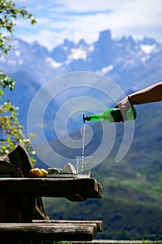 Pouring from high height of natural Asturian cider made fromÂ fermented apples, Asturian cabrales cow blue cheese with view on